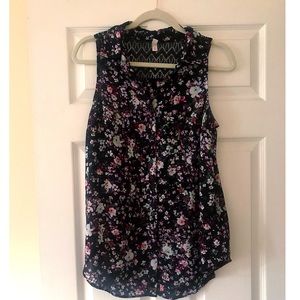Sheer sleeveless floral blouse.